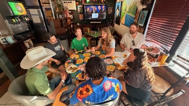 Guests gathered around a table playing Don't Talk About Politics